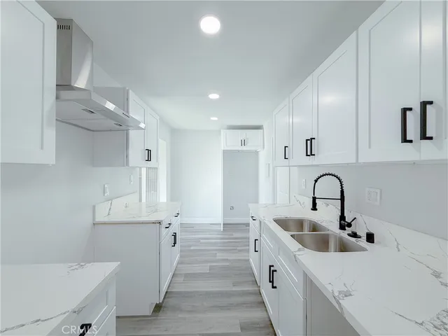 a kitchen with cabinets and wooden floors