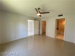 705 Augusta Boulevard, Unit 7055 Naples, FL 34113 - Photo 9 of 18 an empty room with closet and a ceiling fan