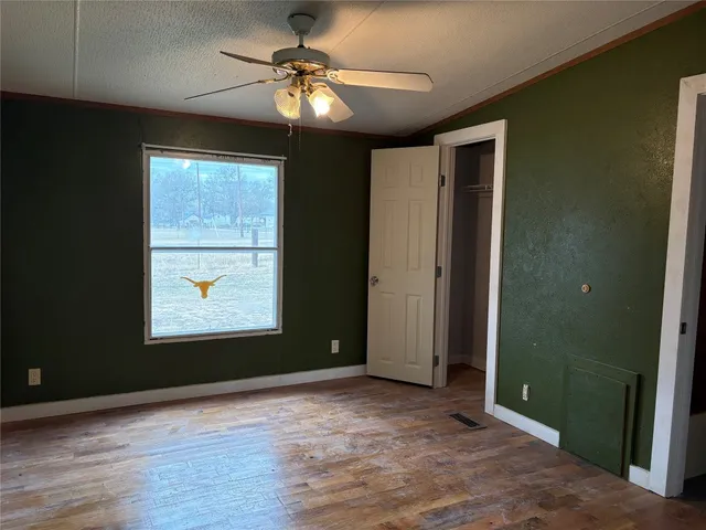 an empty room with windows and closet