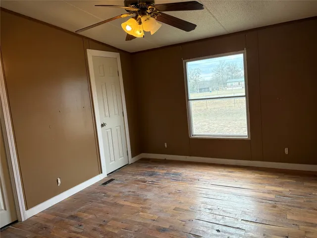 an empty room with windows and closet