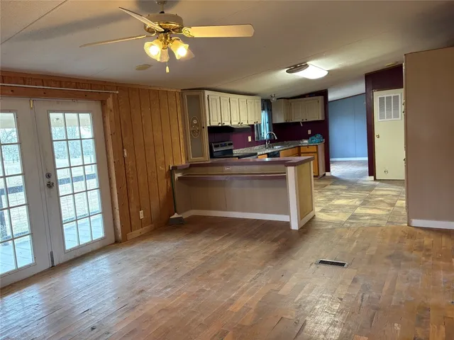 a view of kitchen with stove and cabinets