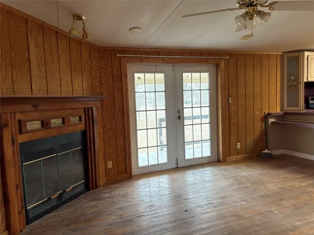 a view of an empty room with a fireplace and a window