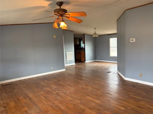 a view of a livingroom with a ceiling fan and window