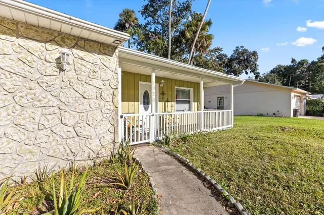 a front view of a house with a garden