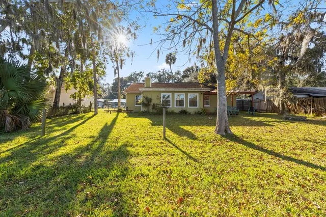 an aerial view of a house with a lake view