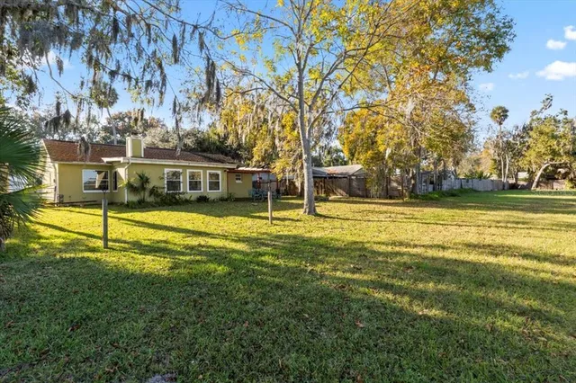 an aerial view of house with yard swimming pool and lake view
