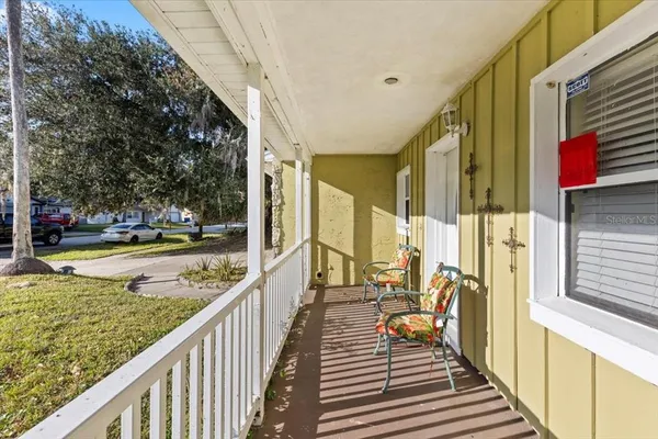 a front view of house with yard and trees in the background