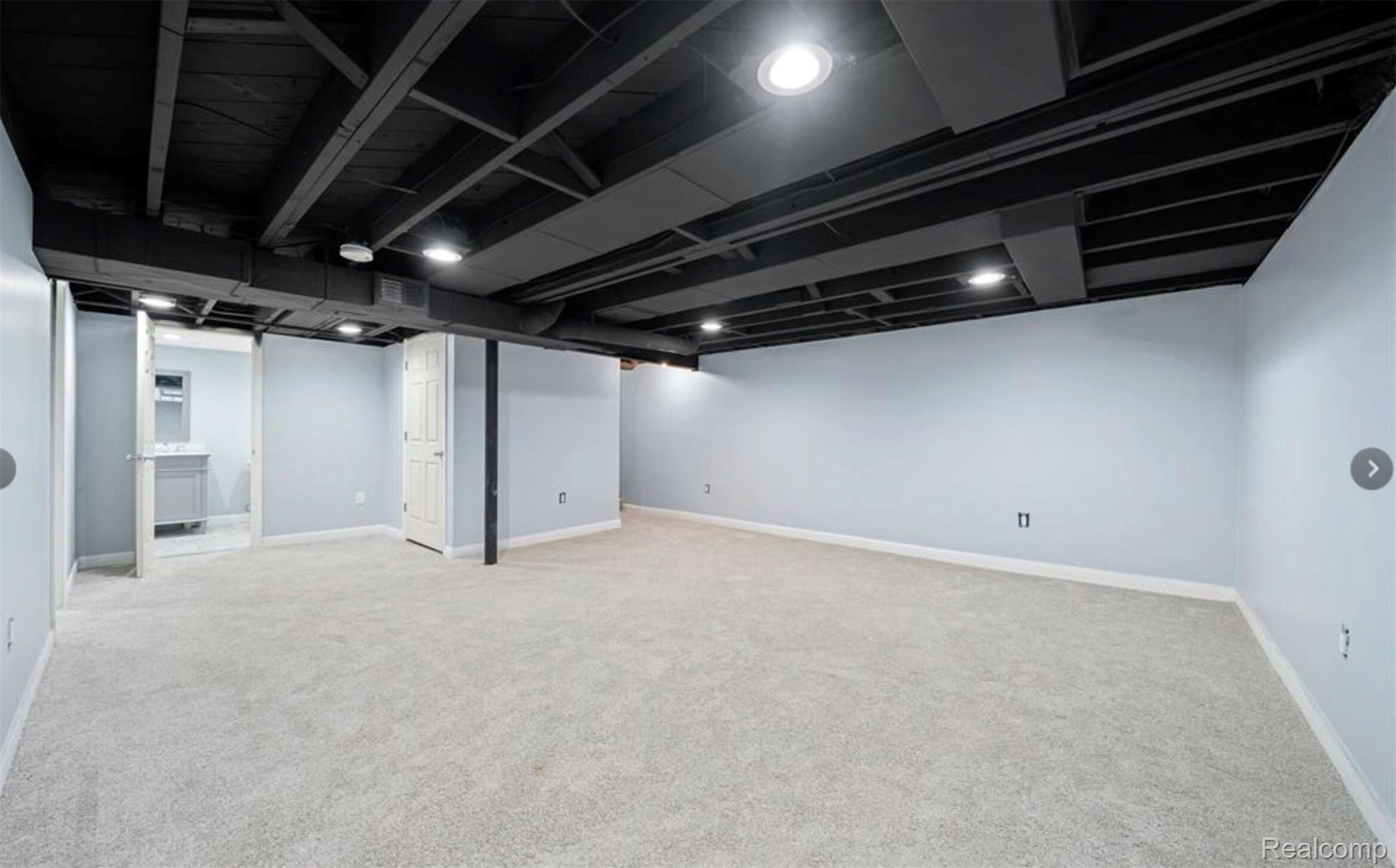 4214 Berkshire Road Royal Oak, MI 48073 - Photo 22 of 27 Spacious finished basement with light gray carpeting and light blue walls