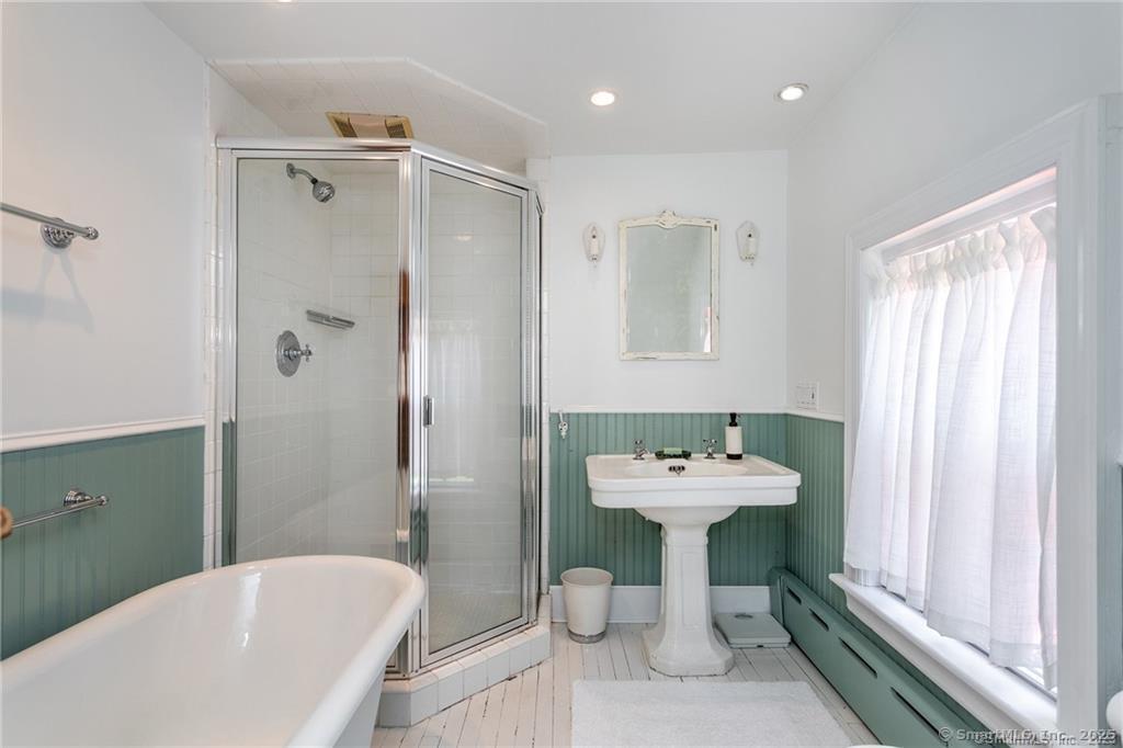 115 River Road Washington, CT 06794 - Photo 13 of 39 a bathroom with a sink mirror and a bathtub