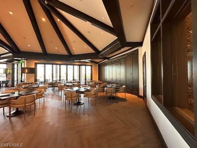 a room with furniture pool table and chairs