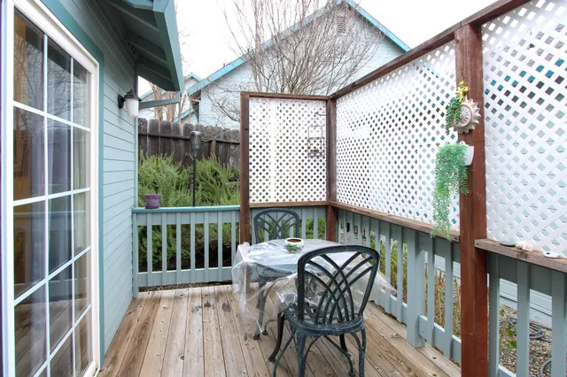 a view of a balcony with two chairs and a wooden floor