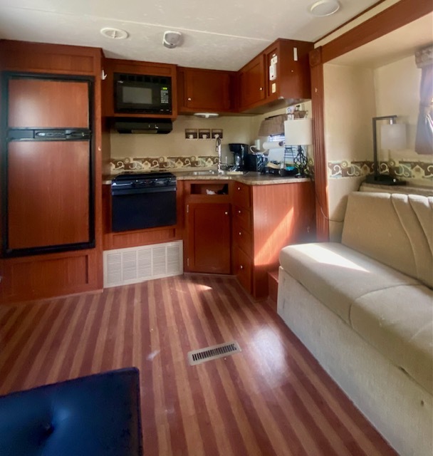17-100 Woodhaven Sublette, IL 61367 - Photo 5 of 11 a kitchen with stainless steel appliances wooden floors and wooden cabinets