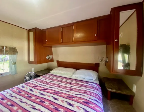 a bedroom with a bed and a potted plant