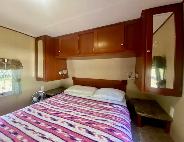 a bedroom with a bed and a potted plant