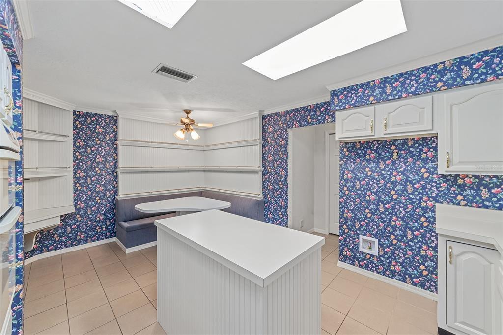 3590 Southwest 24th Avenue Road Ocala, FL 34471 - Photo 21 of 76 Country Kitchen with built in desk area. Help your kiddos or grand kids do home work, study for college or just add your Smart Home Base right in the kitchen.