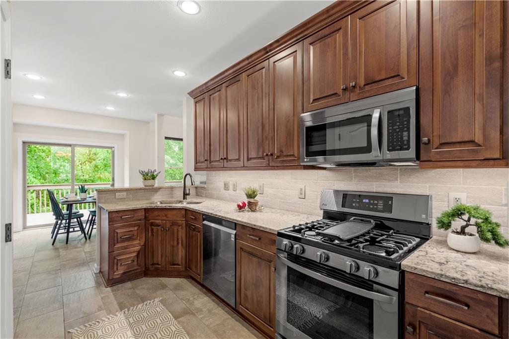 2510 Hilltop Road Presto, PA 15142 - Photo 13 of 36 a kitchen with stainless steel appliances granite countertop wooden cabinets a stove top oven a sink and dishwasher