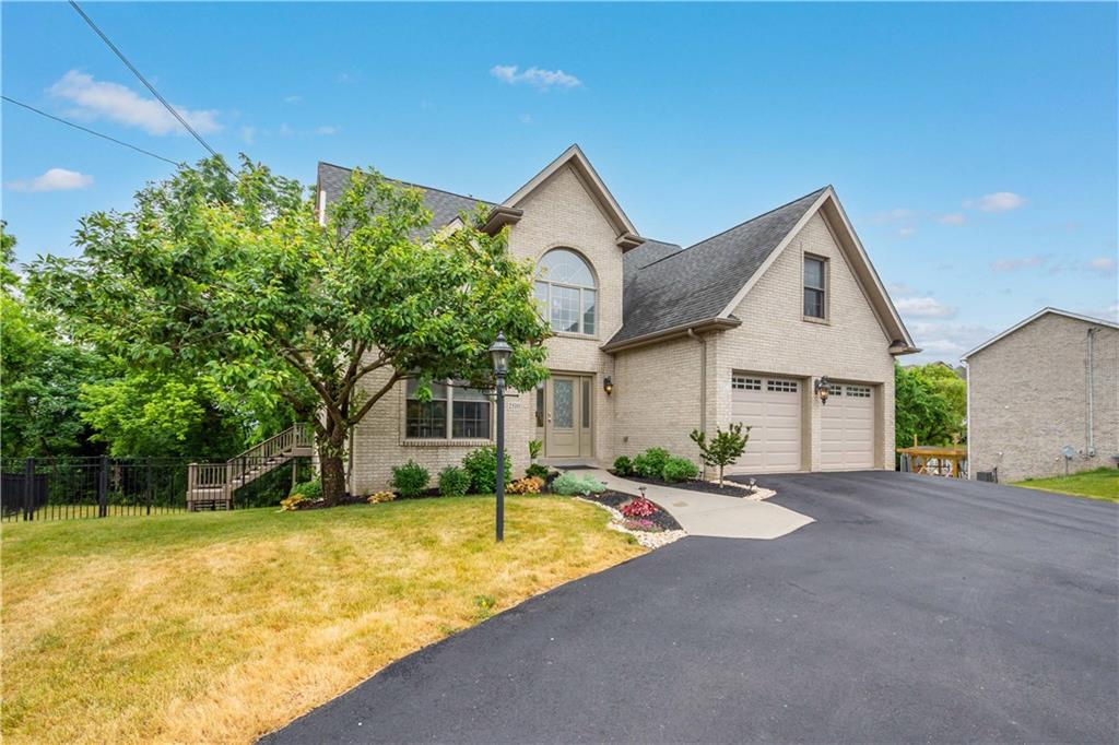 2510 Hilltop Road Presto, PA 15142 - Photo 2 of 36 a front view of a house with a yard and garage