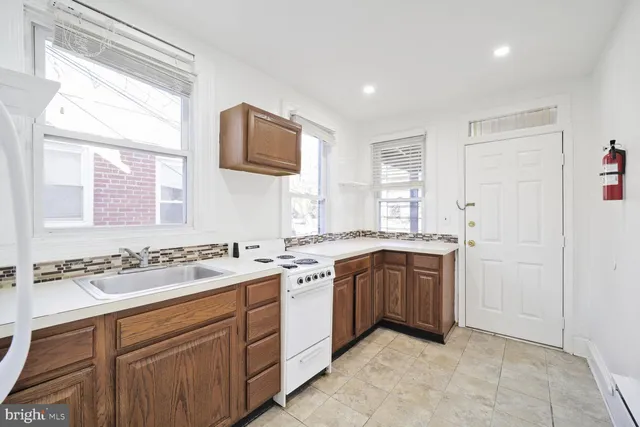 a kitchen with a stove a sink and a refrigerator
