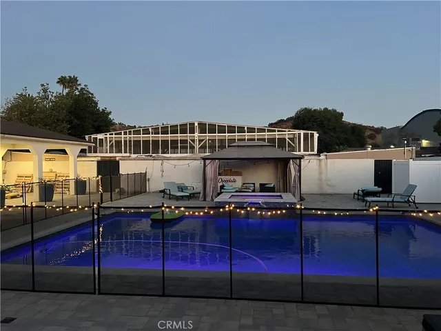 a view of two chairs and table in patio