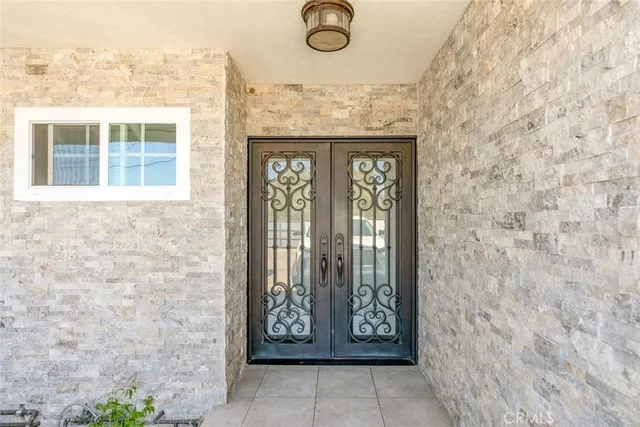 a view of hallway with a large window and wooden floor