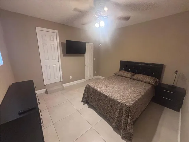 a bedroom with a bed and a television
