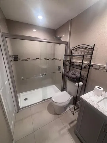 a bathroom with a toilet and a shower