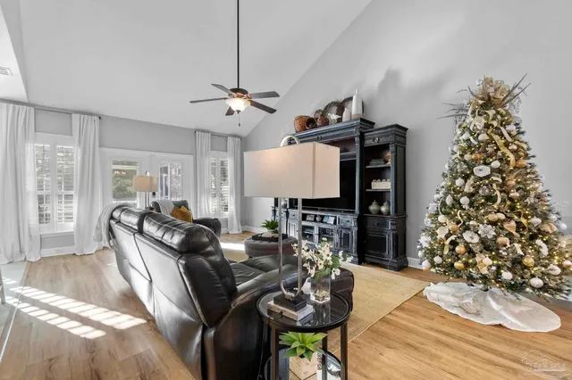 a living room with furniture a dining table and a chandelier