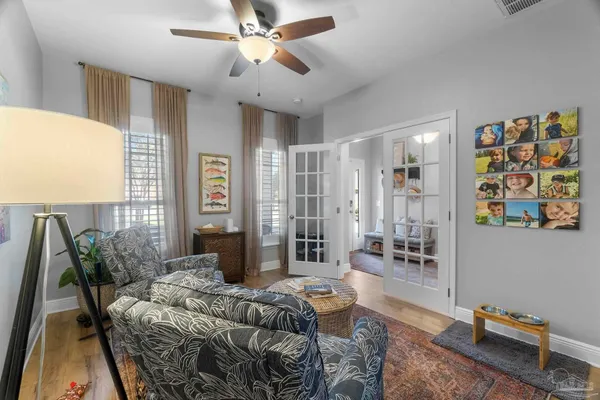 a living room with furniture a dining table and a chandelier