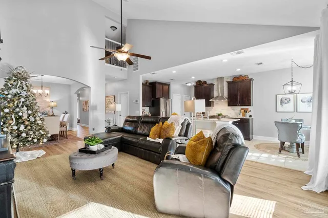 a kitchen with stainless steel appliances granite countertop a sink a stove and a refrigerator