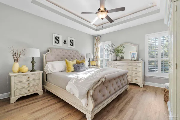 a bathroom with a granite countertop toilet sink and mirror