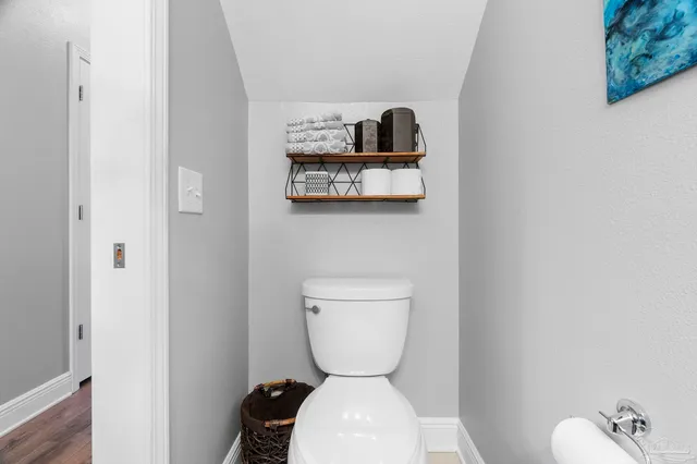 an empty room with closet and fan