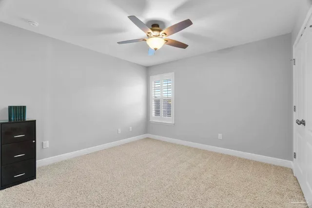 a work room with furniture and a potted plant