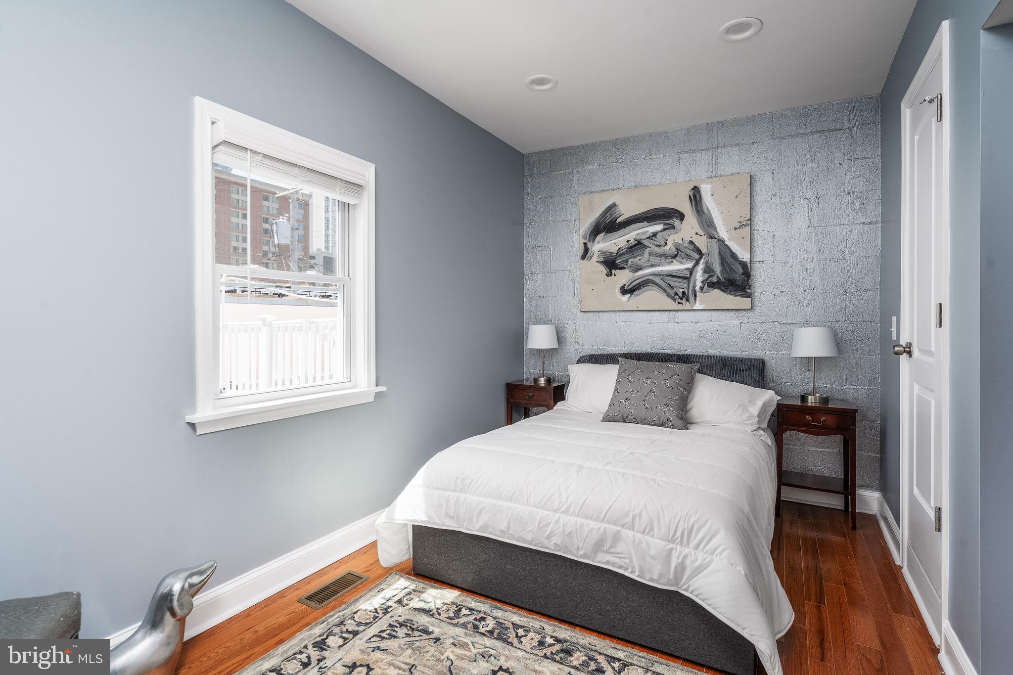 921 Eastern Avenue Baltimore, MD 21202 - Photo 20 of 23 a bedroom with a bed and a window