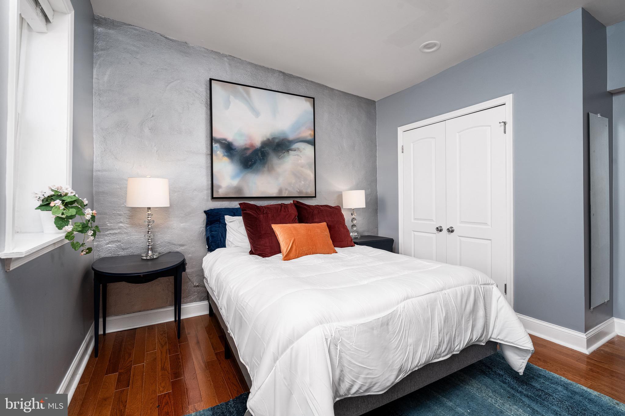 921 Eastern Avenue Baltimore, MD 21202 - Photo 21 of 23 a bedroom with bed and wooden floor