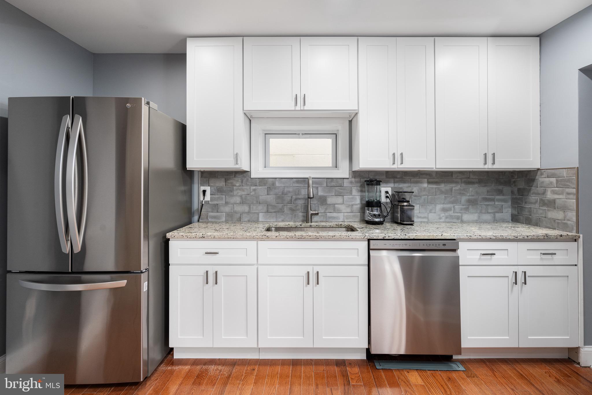 921 Eastern Avenue Baltimore, MD 21202 - Photo 10 of 23 a kitchen with a refrigerator sink and cabinets