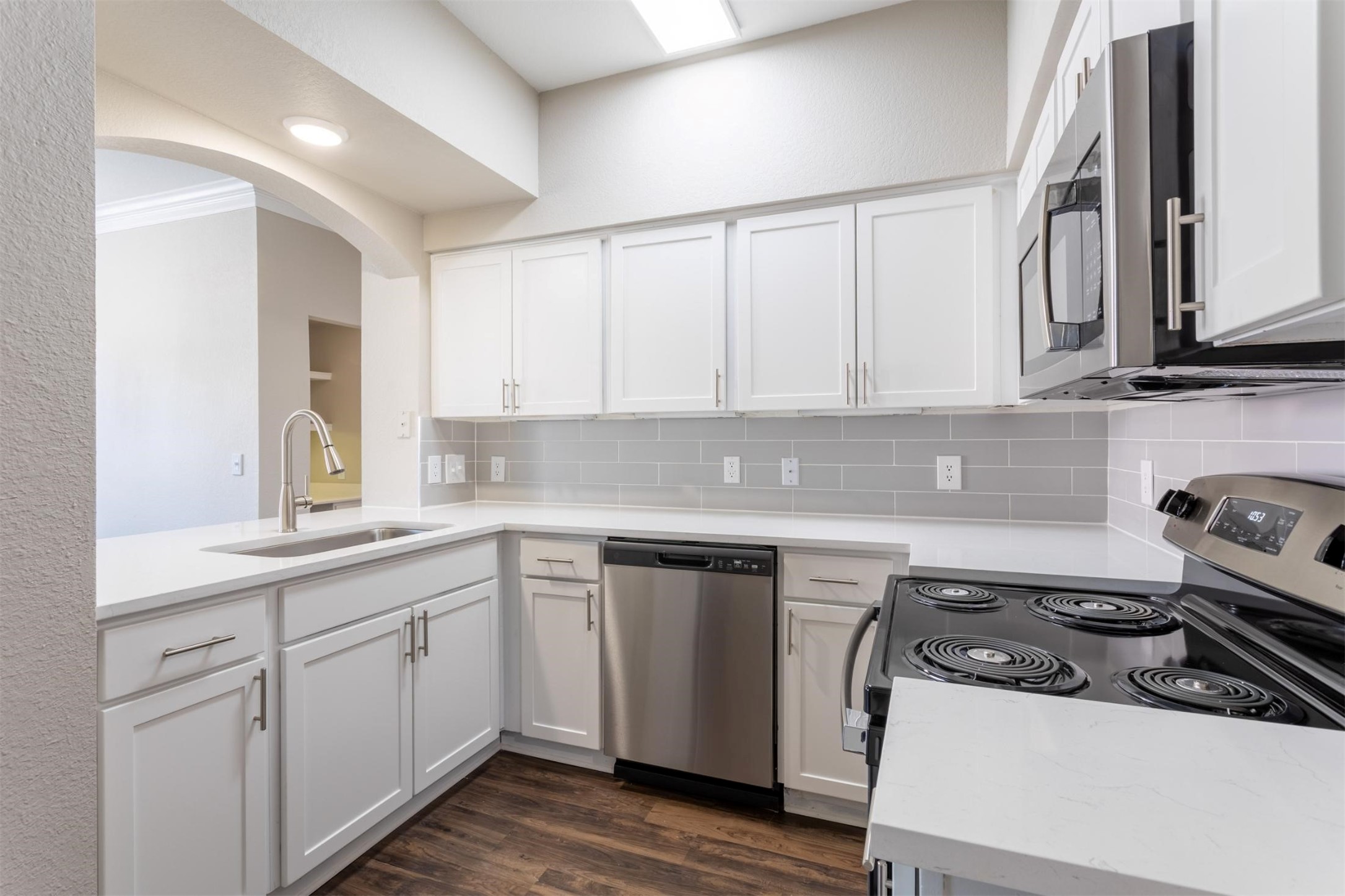 320 Jackson Hill Street, Unit 142 Houston, TX 77007 - Photo 6 of 18 a kitchen with a sink stove and cabinets