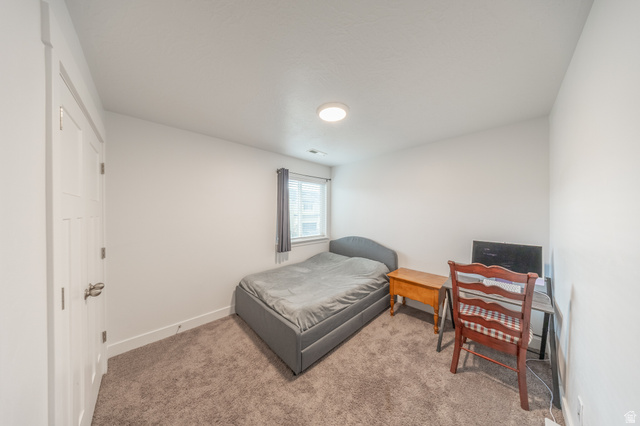 4765 Breezy Patch Road Eagle Mountain, UT 84005 - Photo 20 of 25 Bedroom featuring neutral wall paint, carpet flooring, a single window with blinds, and a flush-mount ceiling light