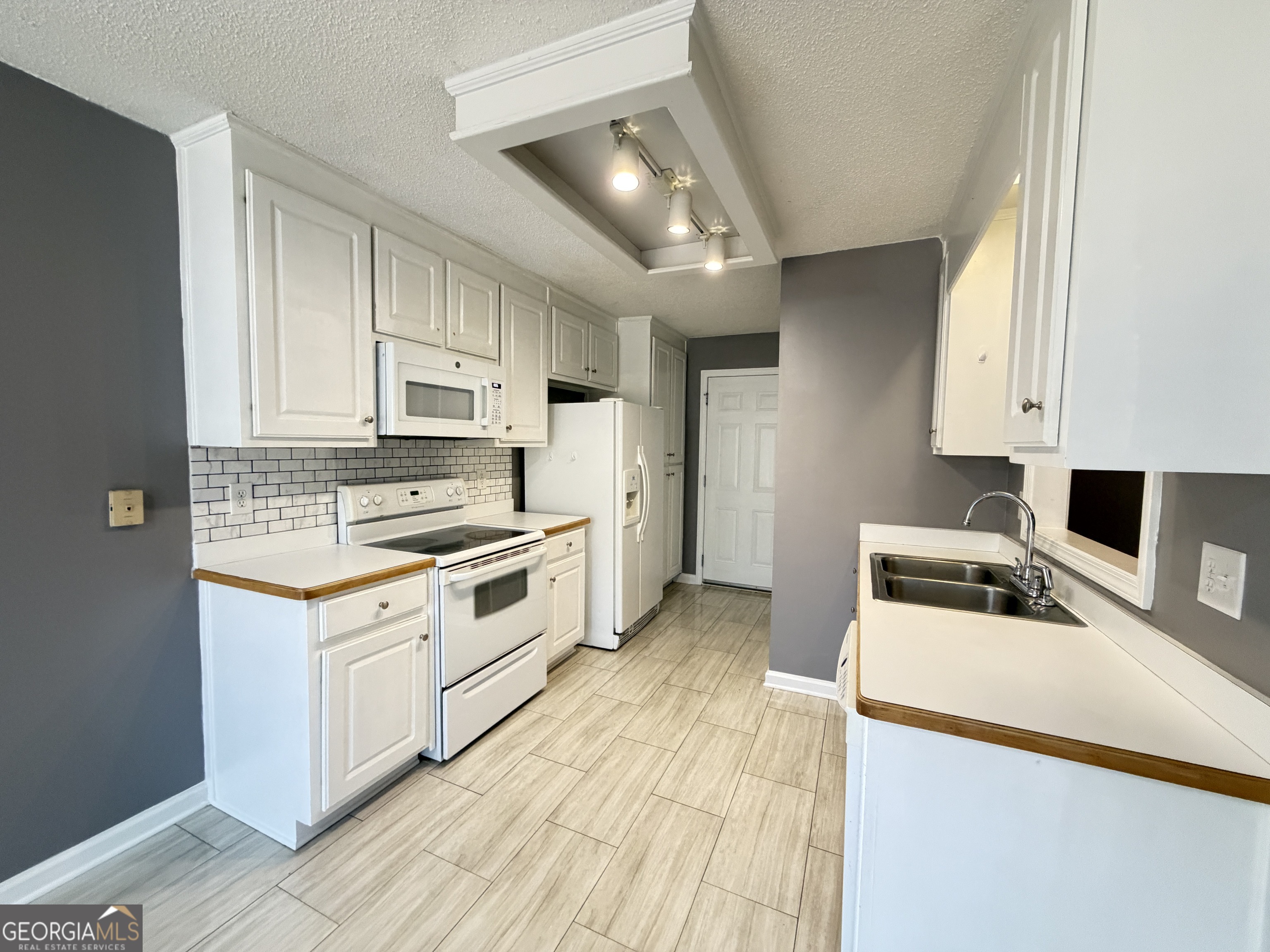 520 Redbud Lane Mount Airy, GA 30563 - Photo 11 of 26 a kitchen with stainless steel appliances white cabinets a sink a stove a refrigerator and cabinets
