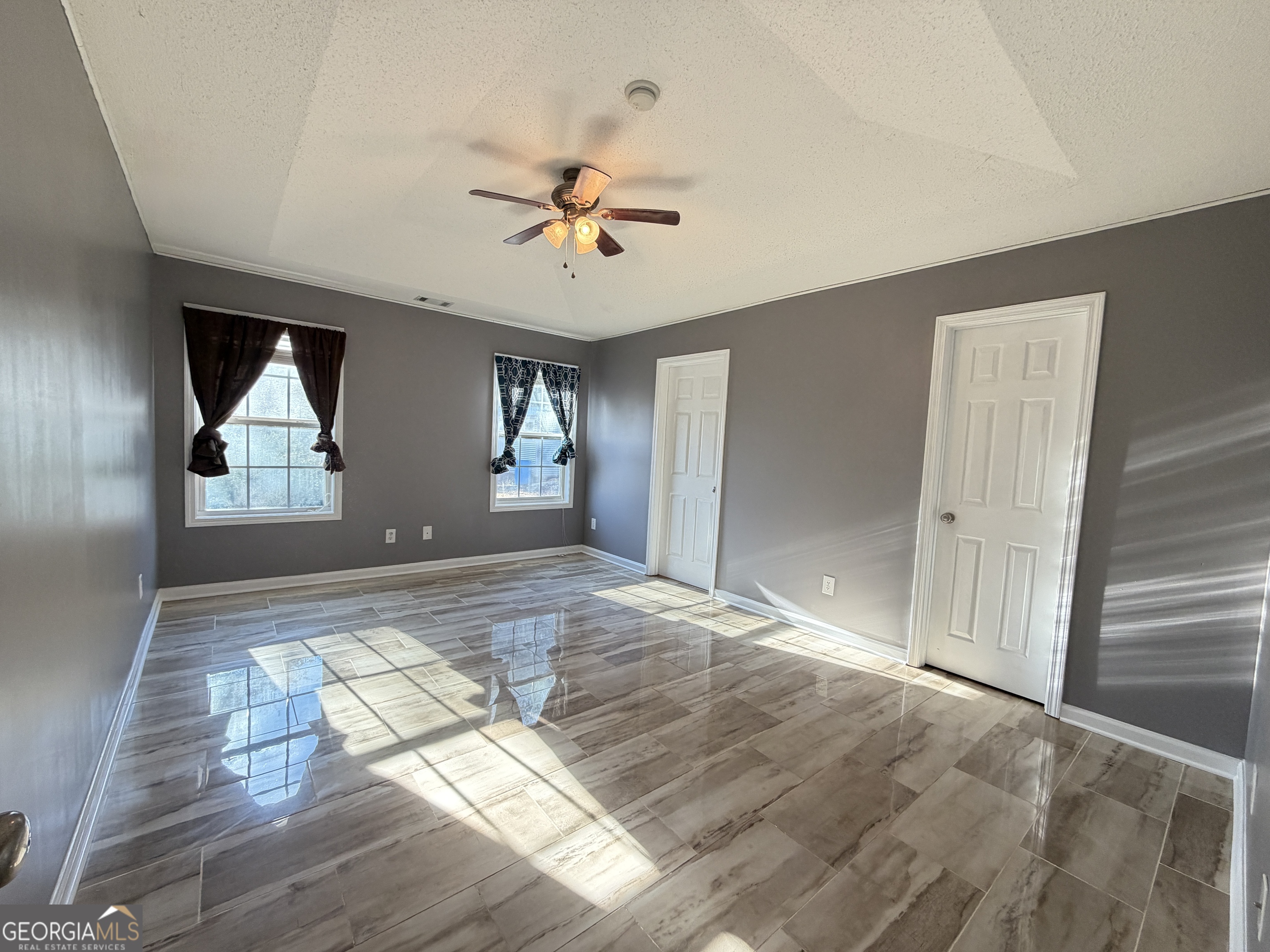 520 Redbud Lane Mount Airy, GA 30563 - Photo 12 of 26 a view of empty room with wooden floor and fan