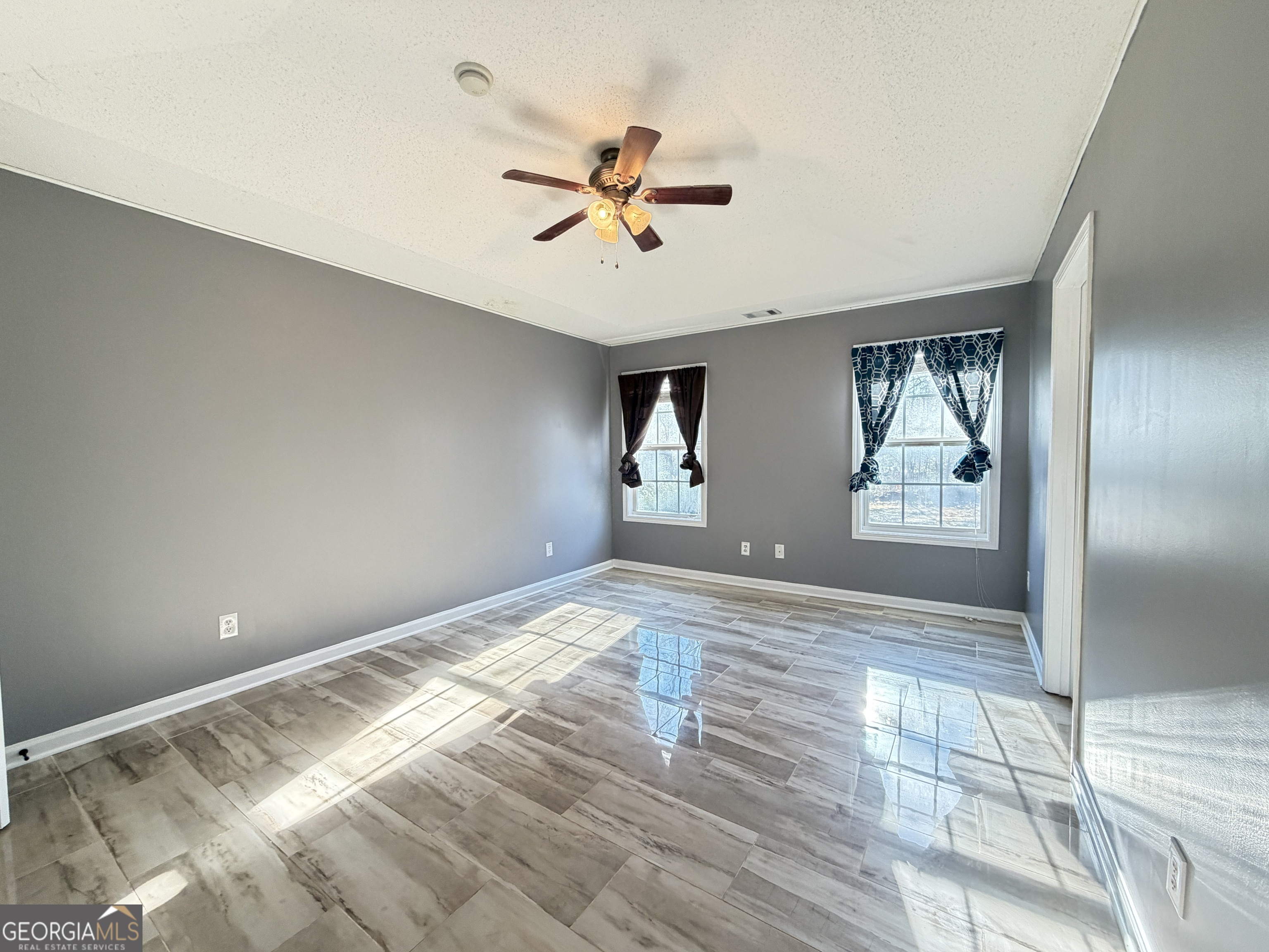 520 Redbud Lane Mount Airy, GA 30563 - Photo 13 of 26 a view of empty room with wooden floor and fan