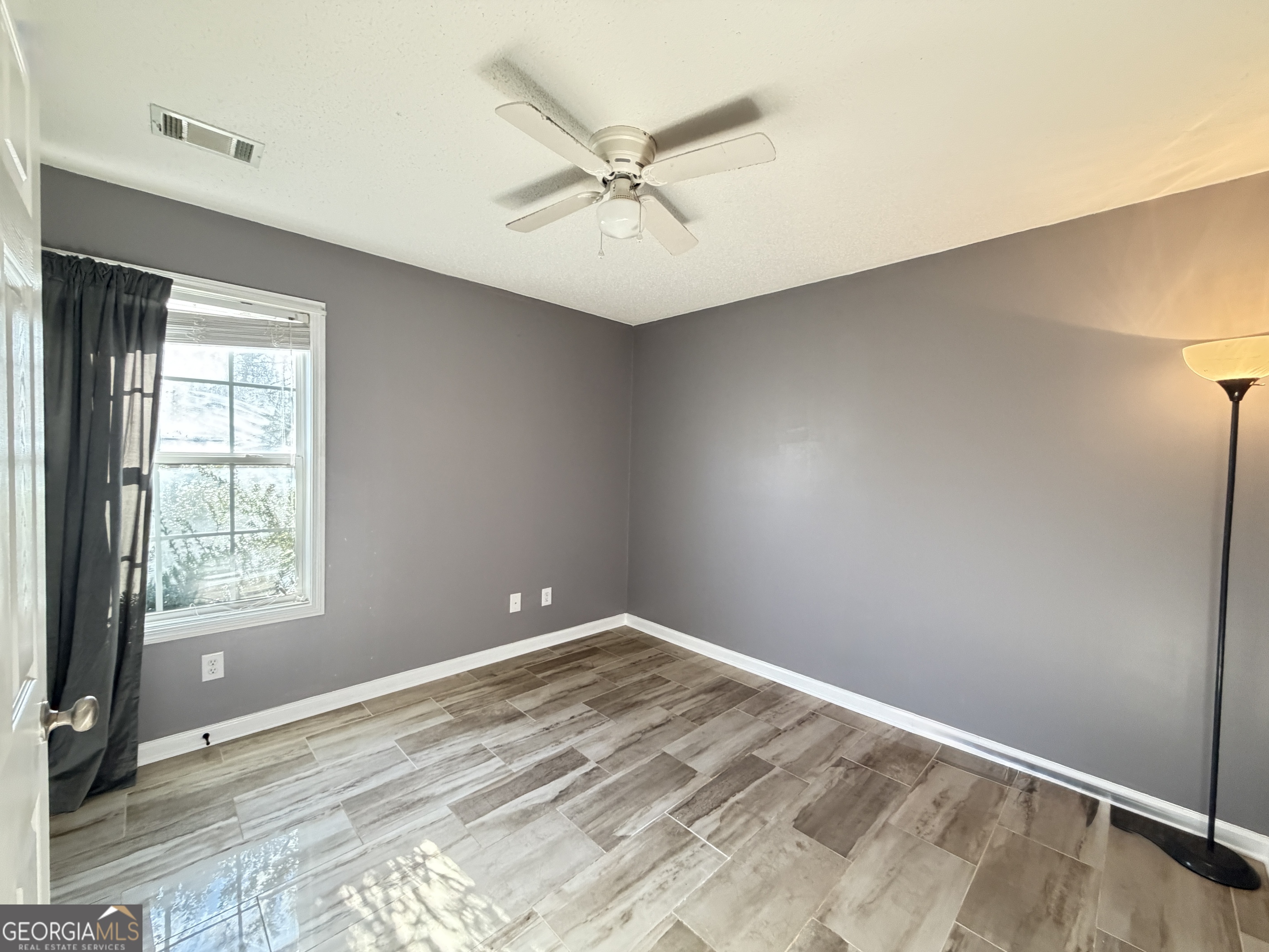 520 Redbud Lane Mount Airy, GA 30563 - Photo 19 of 26 an empty room with a ceiling fan and window