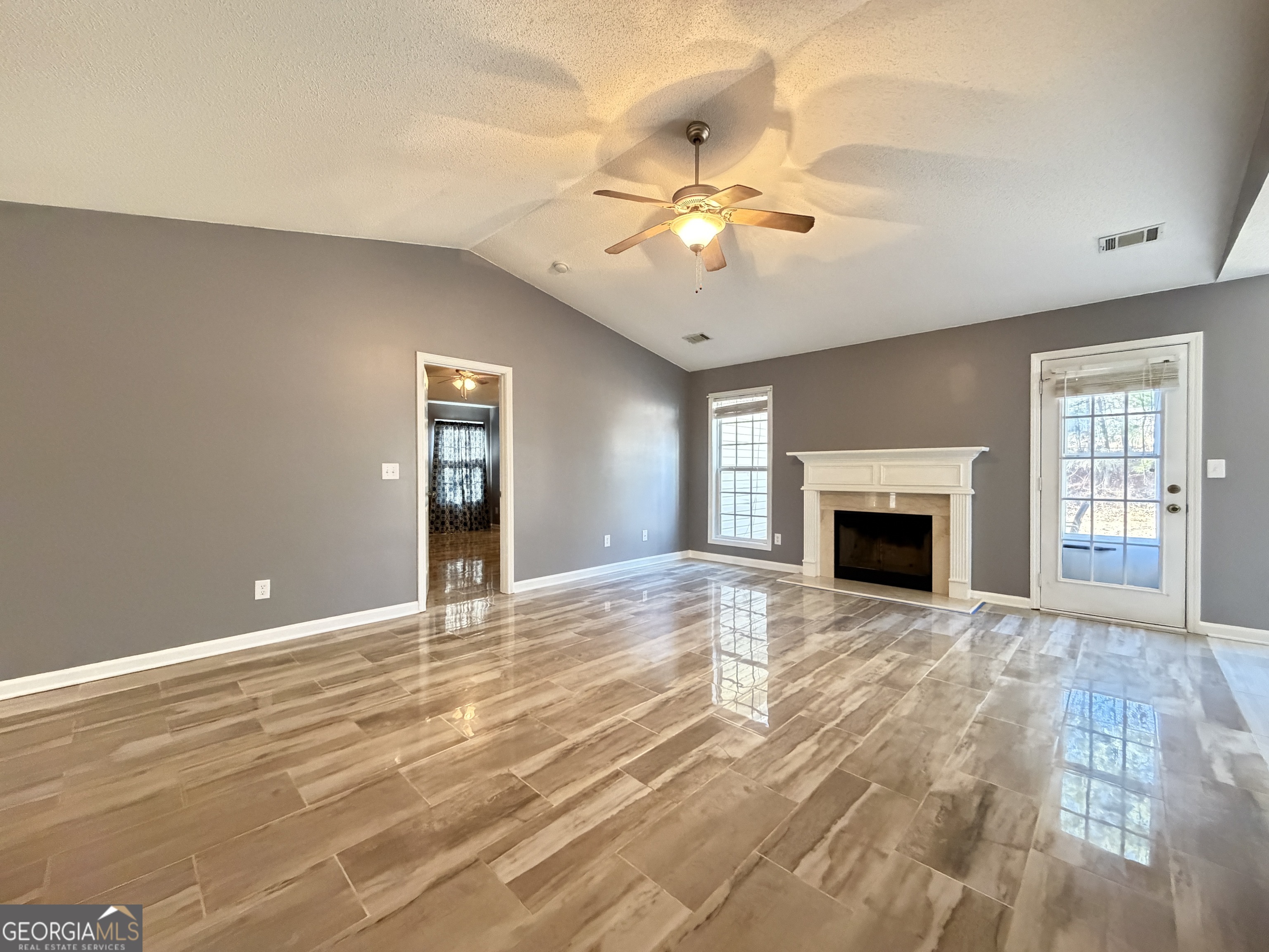520 Redbud Lane Mount Airy, GA 30563 - Photo 5 of 26 a view of an empty room with window and fireplace