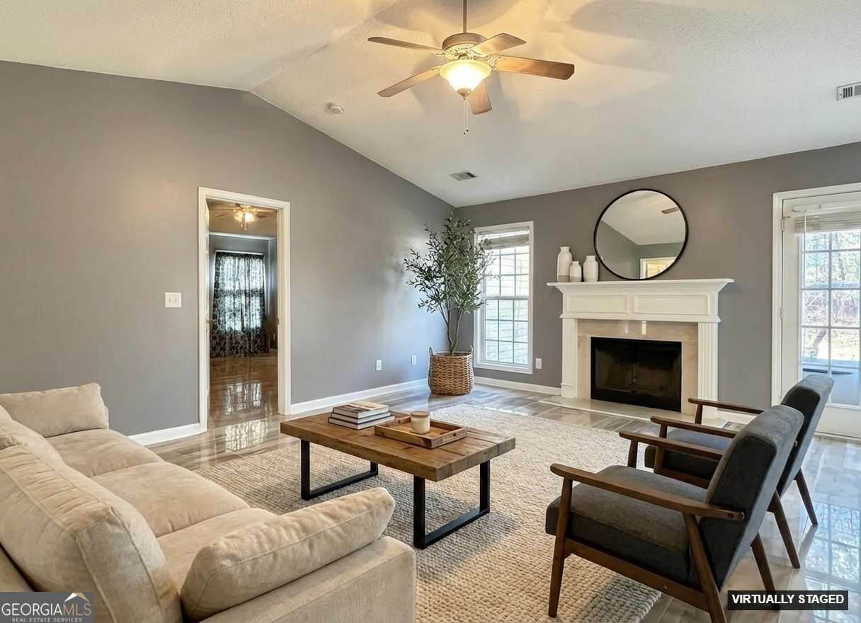520 Redbud Lane Mount Airy, GA 30563 - Photo 6 of 26 a living room with furniture a fireplace and a large window