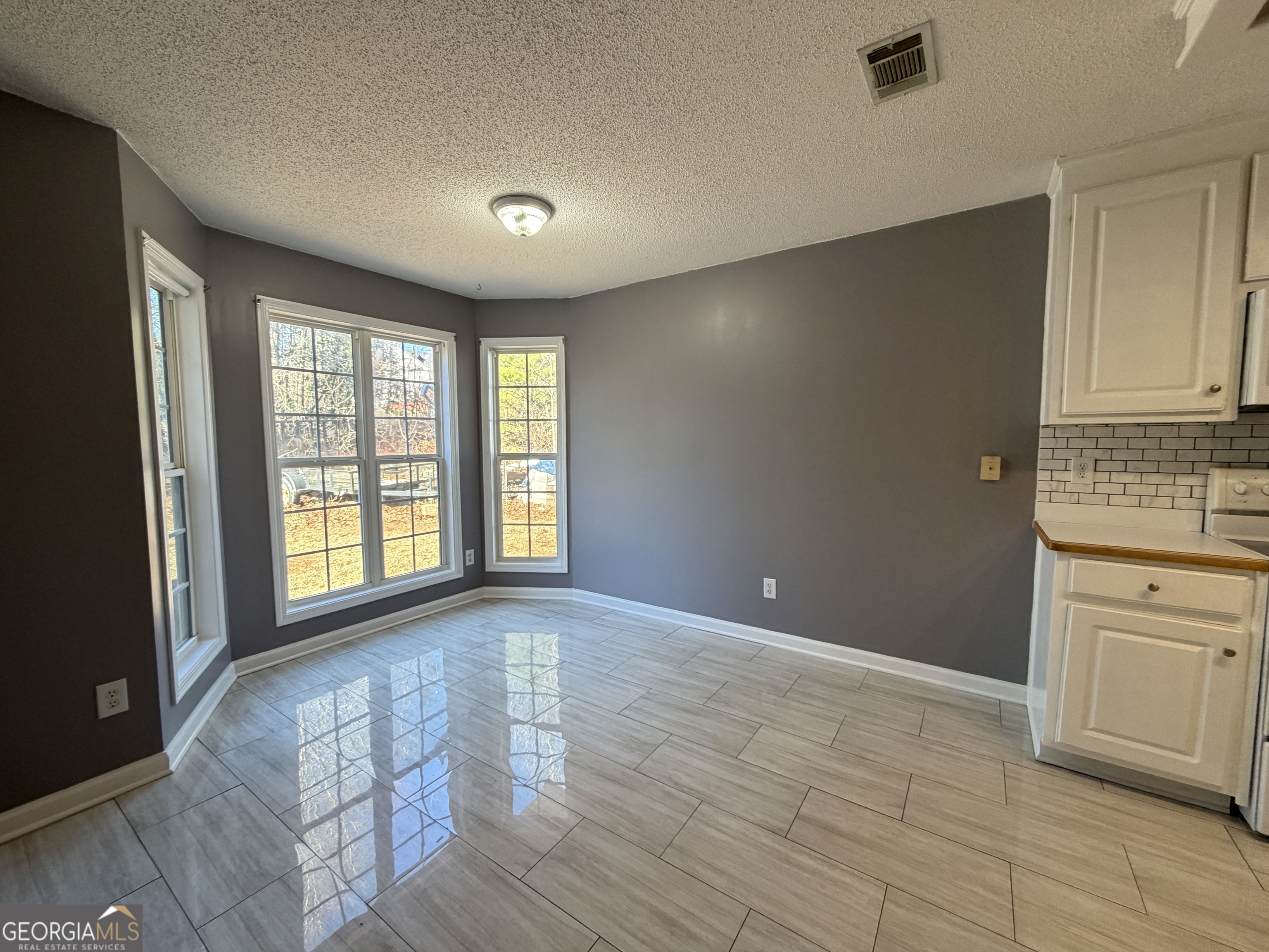 520 Redbud Lane Mount Airy, GA 30563 - Photo 7 of 26 a view of an empty room with a window and wooden floor