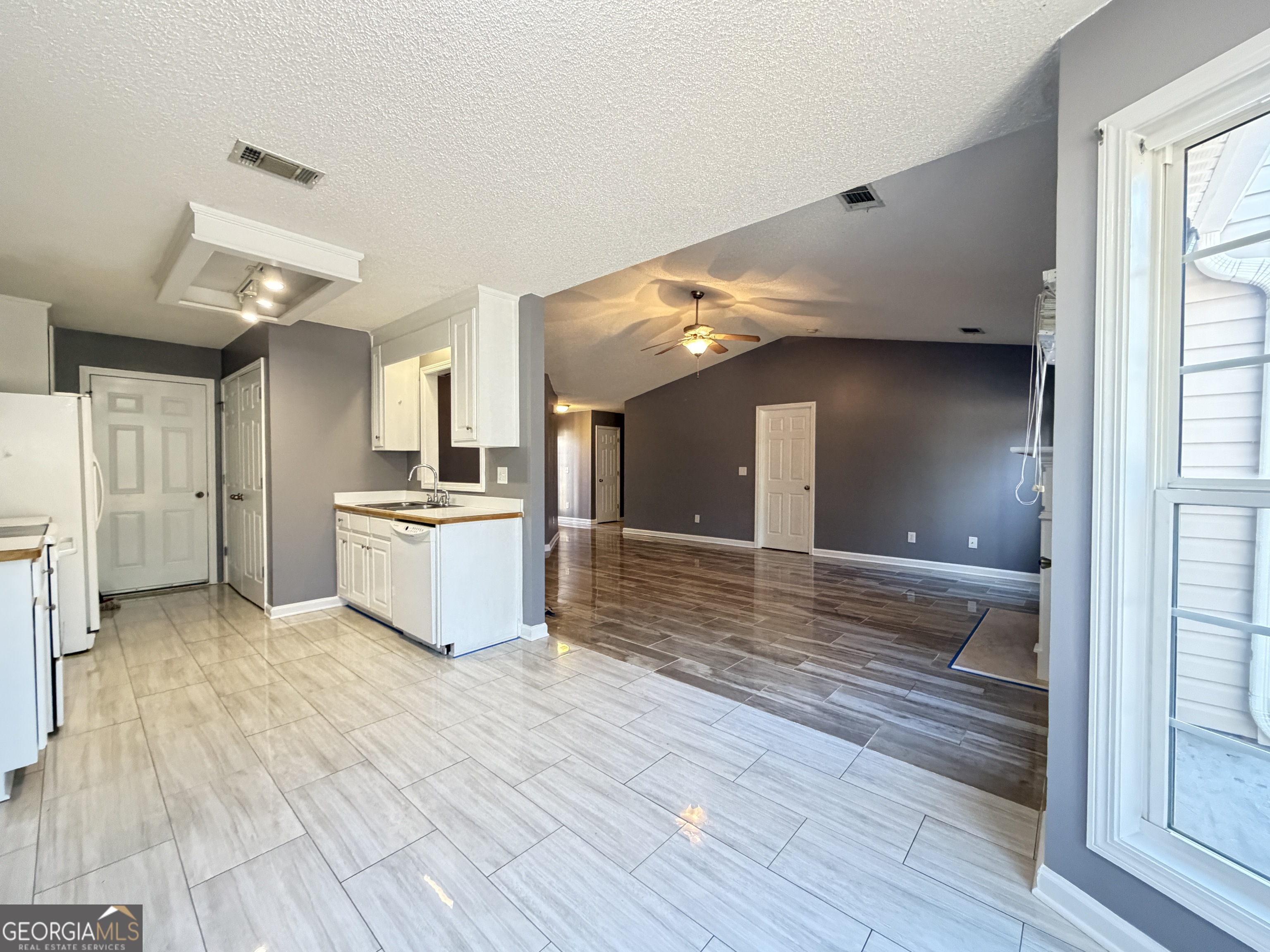 520 Redbud Lane Mount Airy, GA 30563 - Photo 8 of 26 a view of a kitchen with wooden floor and a refrigerator