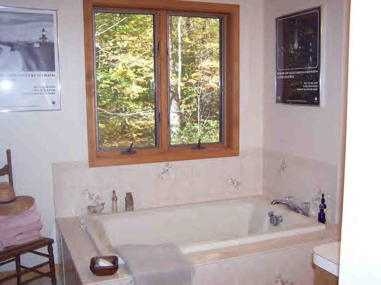 222 Thicket Road Tolland, MA 01034 - Photo 6 of 6 a bathroom with a tub a sink and a window
