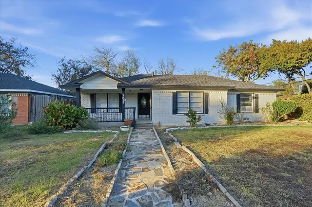 a front view of a house with yard patio and green space