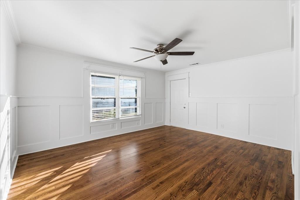 7835 Tillman Street Dallas, TX 75217 - Photo 19 of 34 a view of empty room with wooden floor and fan