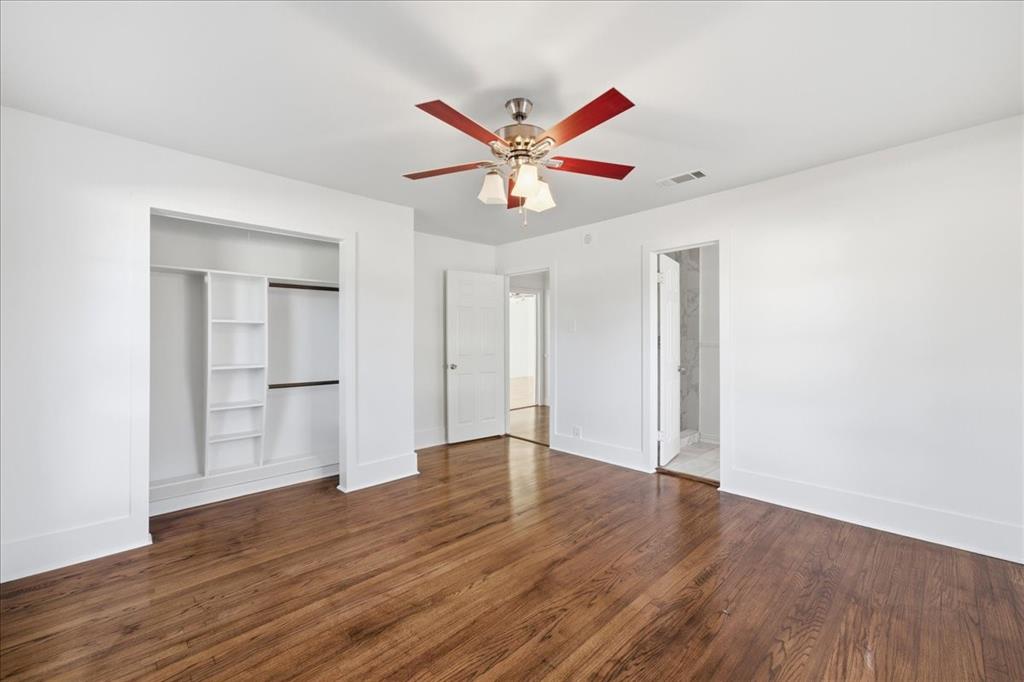 7835 Tillman Street Dallas, TX 75217 - Photo 24 of 34 an empty room with wooden floor ceiling fan and window
