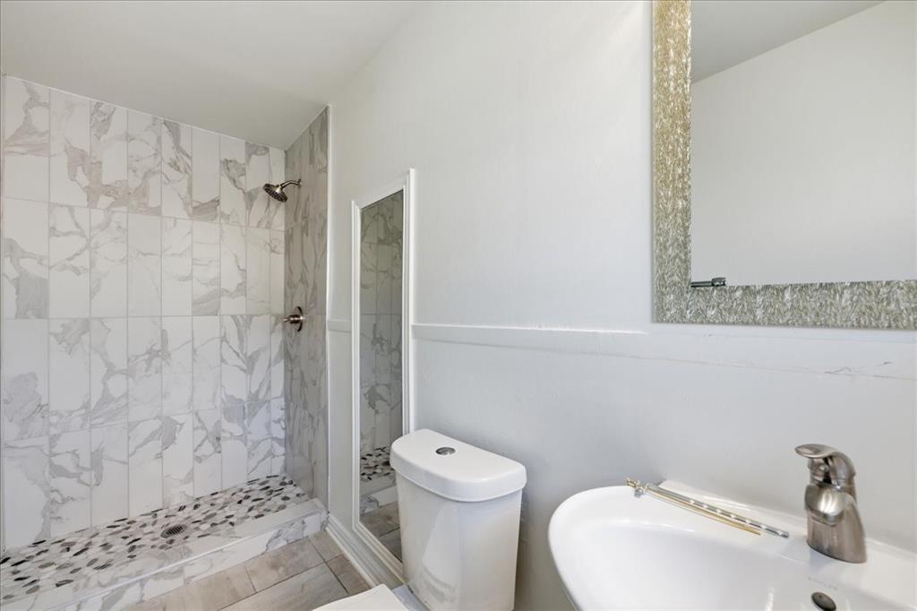 7835 Tillman Street Dallas, TX 75217 - Photo 26 of 34 a bathroom with a toilet and a shower